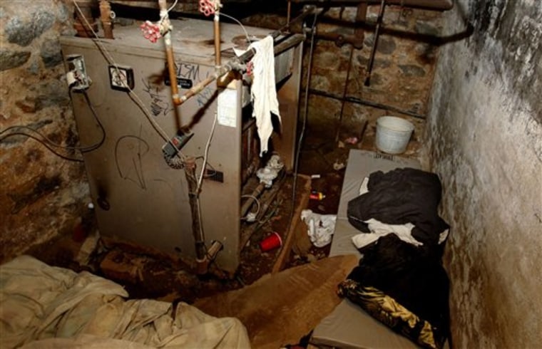 The dank basement room in Philadelphia in which four weak and malnourished mentally disabled adults, one chained to the boiler, were found locked up on Saturday is shown Monday.